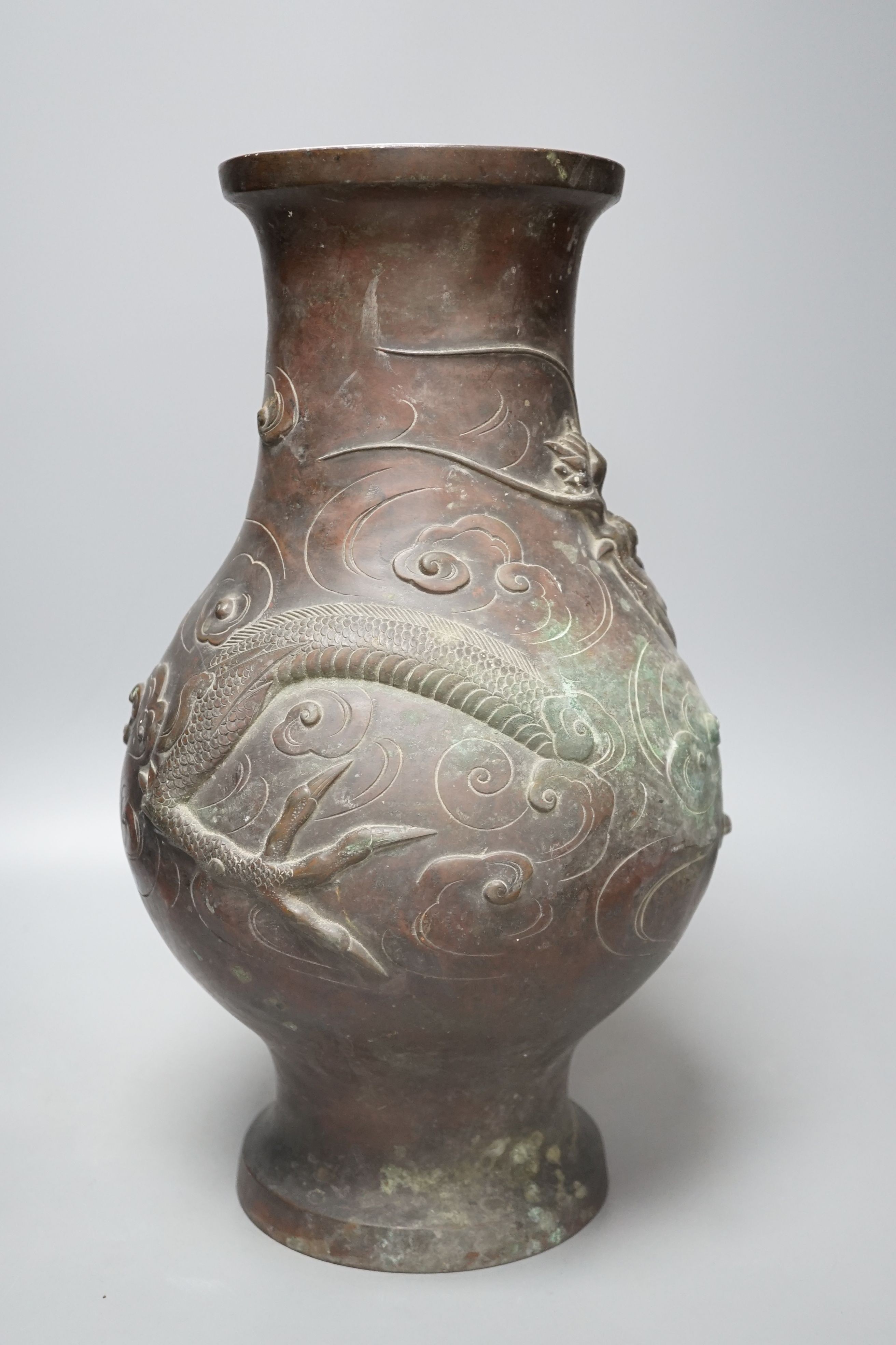 A large 19th century Japanese bronze dragon designed vase, 40cms high.